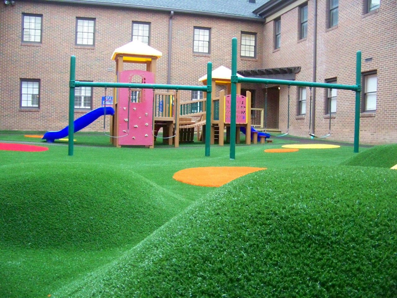 Hilly artificial turf playground by Southwest Greens